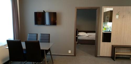 a room with a table and chairs and a bedroom at Třeboňské Apartmány in Třeboň