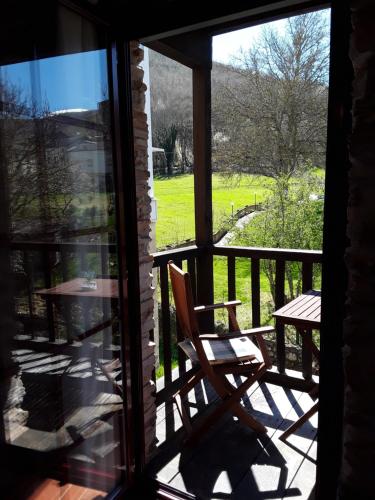 a view of a porch with a chair and a table at Las Rocas in Vega de Valcarce