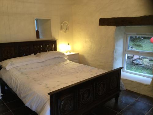 a bedroom with a large bed and a window at Comraich in Tokavaig