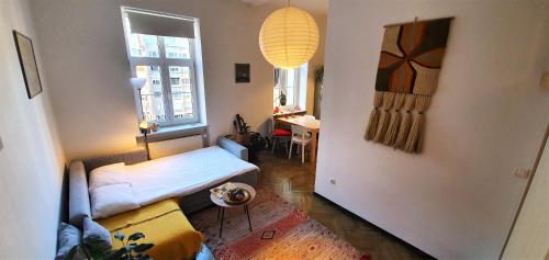 a room with two beds and a table in it at Cosy Ljubljana Loft in Ljubljana