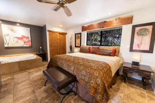 a bedroom with a large bed and a bath tub at A Sunset Chateau in Sedona