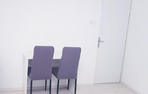 a table and two chairs in a white room at David 3 in Pula