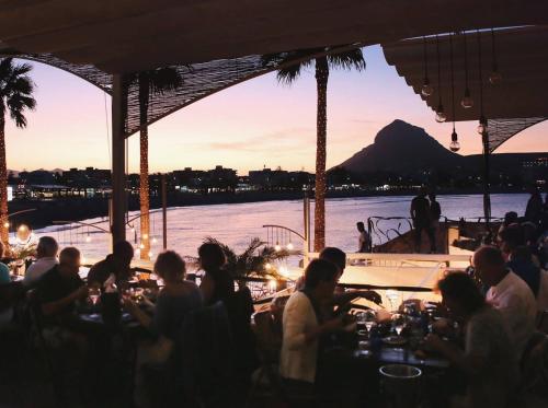 a group of people sitting at a table on a boat at Royal Garden Santa Clara in Jávea
