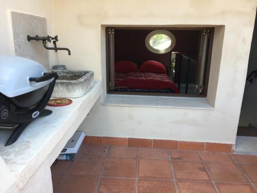 a bathroom with a bed and a sink and a mirror at La maussanaise in Maussane-les-Alpilles