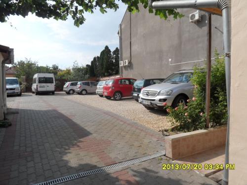 a row of cars parked in a parking lot at Kálmán Panzió in Szeged