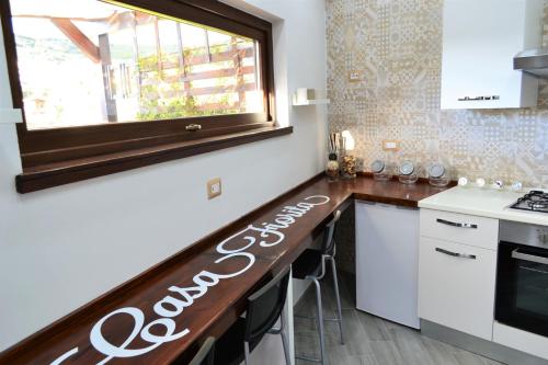 a kitchen with a counter top with a window at Casa Fiorita in Gragnano