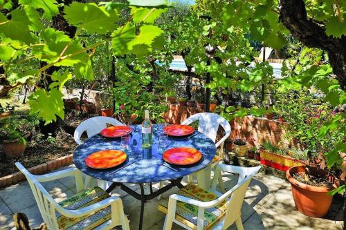 a blue table with plates of food on a patio at Ma Vie La in Fayence