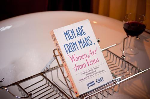 a book in a basket on a table with a glass of wine at Walford Court in Leintwardine