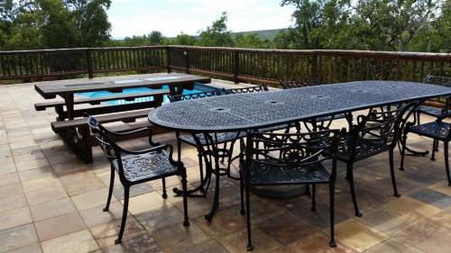 a table and chairs sitting on a patio at Hadeda Lodge, Mabalingwe in Warmbaths