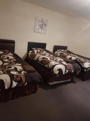 A bed or beds in a room at The Crescent Budget Hotel 