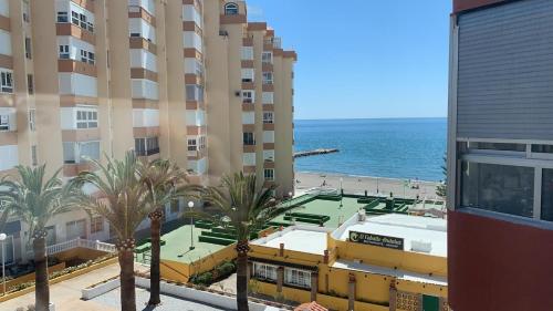 a view of the beach from the balcony of a building at Apartamento Turistico Peñalver Playa 316 in Torrox Costa