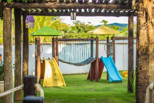 a playground with a bunch of slides and swings at Pousada das Seriemas in Pirenópolis