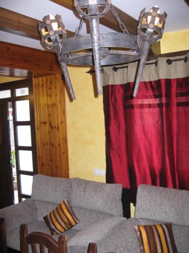 a chandelier in a living room with two couches at Casa Herrero in Oto