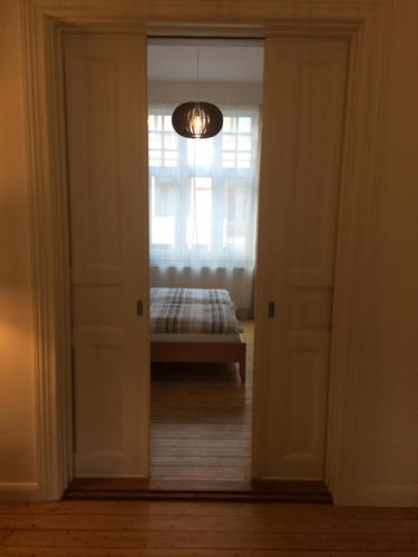 a door leading to a bedroom with a bed in a room at holiday-apartments in Bremen