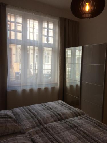 a bedroom with a bed in front of a window at holiday-apartments in Bremen