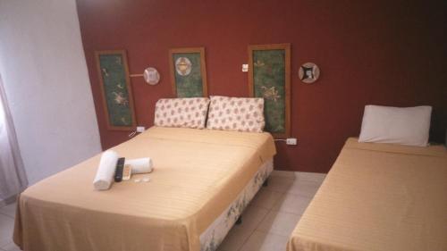 a bedroom with two beds with towels on them at Petit Hotel Panambi in Puerto Iguazú