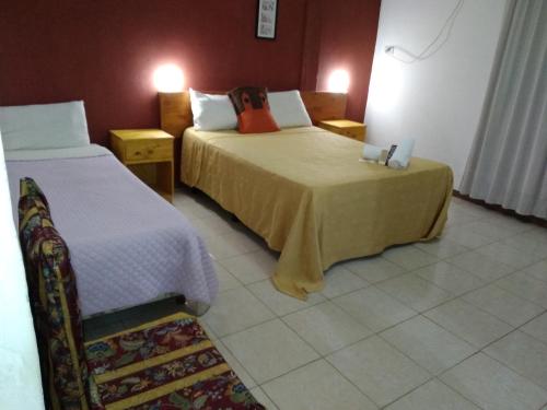 a hotel room with two beds in a room at Petit Hotel Panambi in Puerto Iguazú