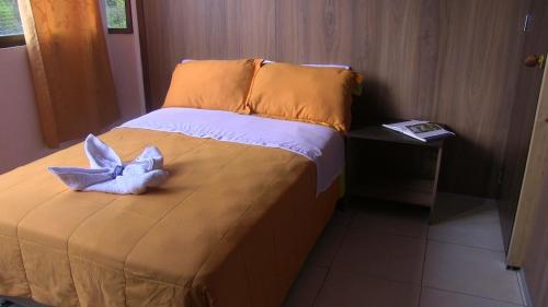 a bedroom with a bed with a blue bow on it at Hotel Mónaco de Fusa in Fusagasuga