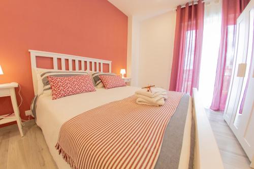 a bedroom with a bed with orange walls and windows at Civico 364 in Naples