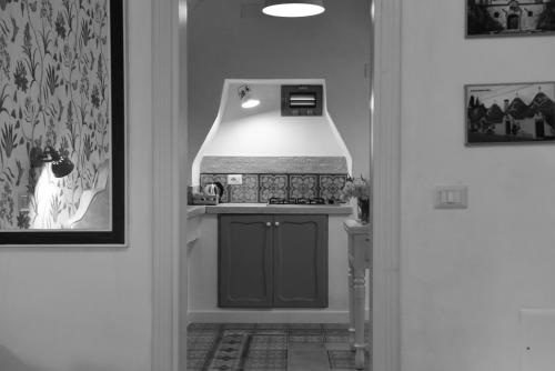 a hallway with a kitchen with a sink in it at Casa Mida - Guest House in Pezze di Greco
