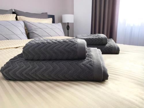 3 almohadas en una cama en un dormitorio en MHC Quiet Deluxe Suite near Downtown - Free Parking, en Brasov