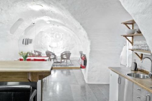 a kitchen and dining room with a table and chairs at Ramilton Old Town Hostel in Stockholm