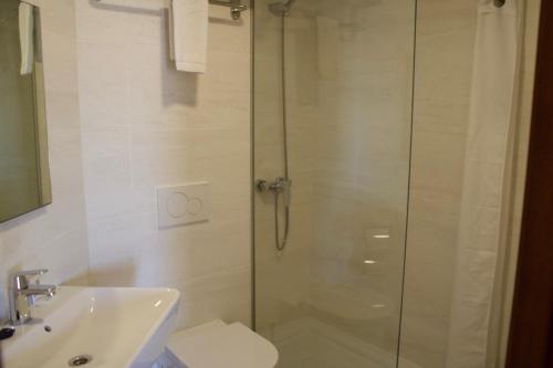 a bathroom with a shower and a toilet and a sink at Hotel Vista Odin in Playa de Palma