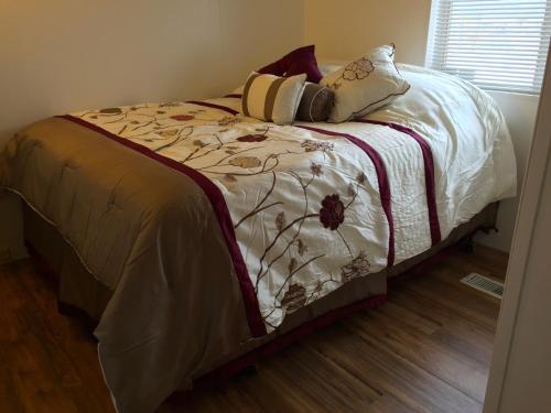 a bed with a white comforter and pillows on it at Delight's Hot Springs Resort in Tecopa