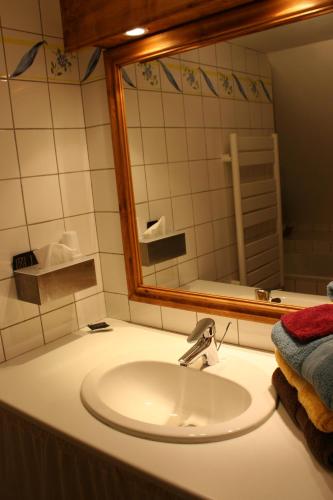a bathroom with a sink and a mirror at B&B au petit tambour d'Autingues in Autingues