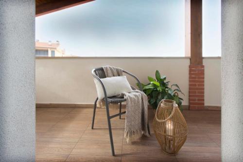 a chair on a balcony with a laptop on it at El Mirador de Eloísa in Rodezno