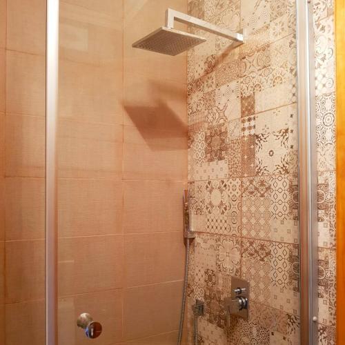 a shower with a glass door in a bathroom at Sunshine Court in St Paul's Bay