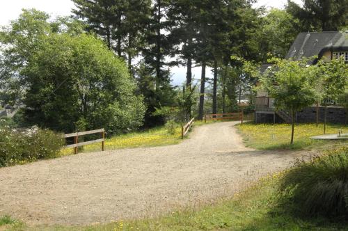 a dirt road next to a house and trees at Ye Olde Danish Inn in Ferndale