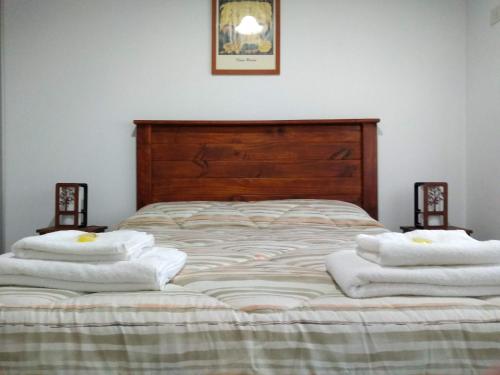 a bedroom with a bed with towels on it at CASA FUNES in Funes