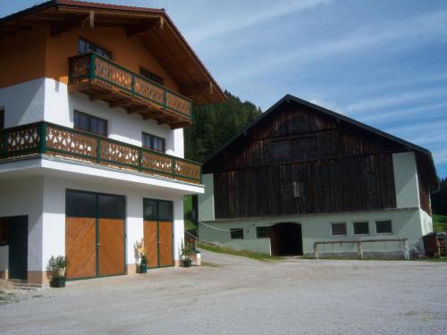 two buildings with wooden doors and balconies on them at Appartement zum Rössl in Ramsau am Dachstein