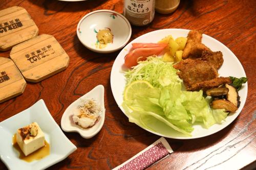 a table with a plate of food on a table at ファミリー不向き!!素泊まり一棟貸切りではない個室の静かな方限定無料WiFi in Irumagawa