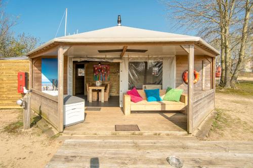a gazebo with a bench and a table at Marinaparcs Almere in Almere