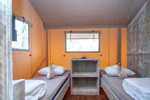 a small room with two beds and a window at Marinaparcs Almere in Almere