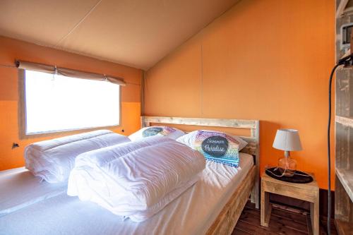 a bedroom with two beds and an orange wall at Marinaparcs Almere in Almere