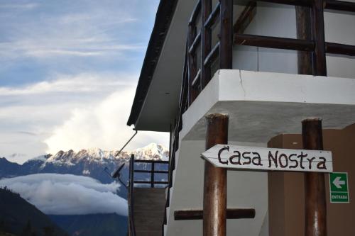 a sign on the side of a building with a mountain at CasaNostra Choquequirao in Cachora