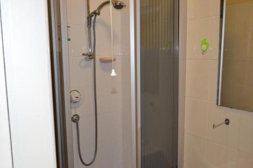 a shower in a bathroom with a glass door at Croft Hotel in Leicester