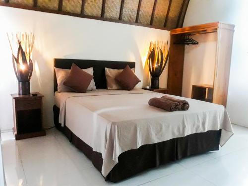 Cama o camas de una habitación en Gili Malibu Bungalows