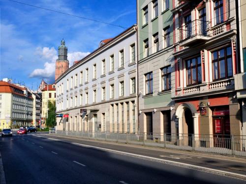 a city street with buildings on the side of the road at SleepWalker Boutique Suites in Wrocław