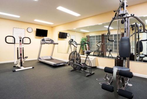 a gym with bikes and tread machines in a room at Baymont by Wyndham Prattville - Montgomery in Prattville
