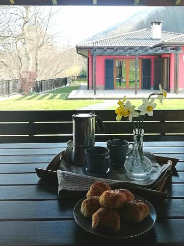 a table with two plates of pastries on it at Boyana Vacation Houses in Cherni Vit