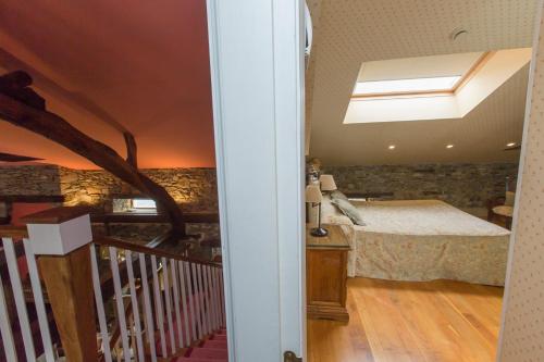 a bedroom with a bed and a skylight at Hotel Rural Casa Xusto in La Caridad