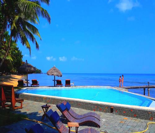 a swimming pool with the ocean in the background at Libertalia Hotel in Sainte Marie