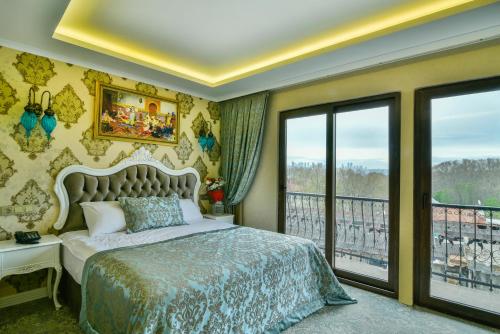 a bedroom with a bed and a balcony at Bon Hotel Old City in Istanbul