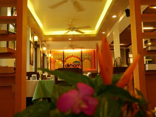 a dining room with a table and a ceiling fan at Bangtao Beach Chalet Resort in Bang Tao Beach