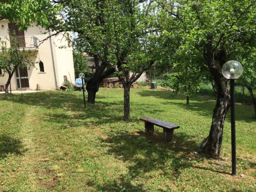 a park with a bench and trees and a building at Casa vacanze da Medardo in Gagliano Aterno