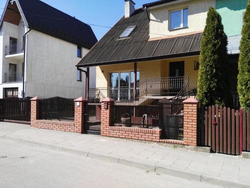 a brick fence in front of a house at POKÓJ MERY in Augustów